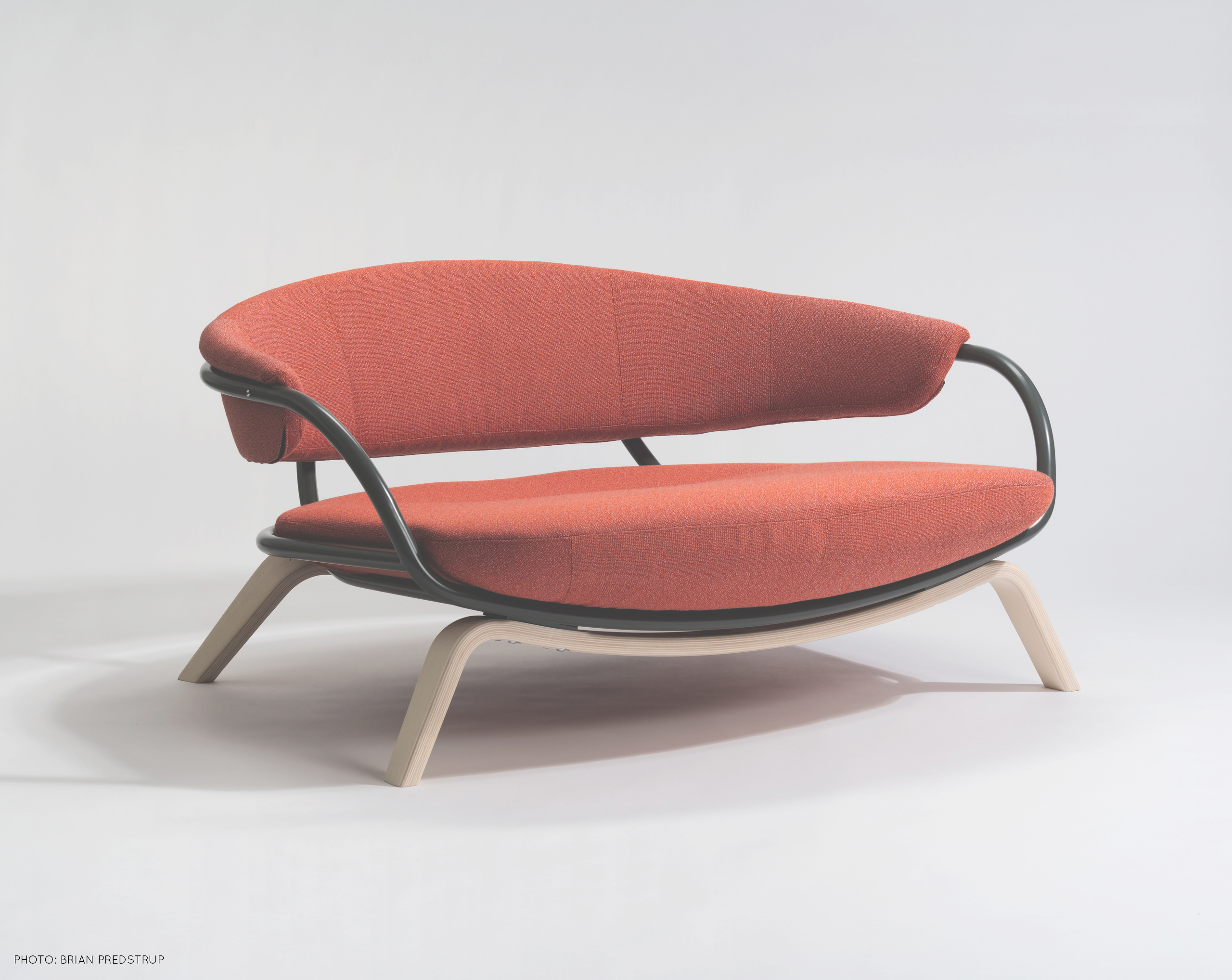 Orange armchair for two persons, inspired by Ingmar Bergman and built in Småland, by Sebastian Galo